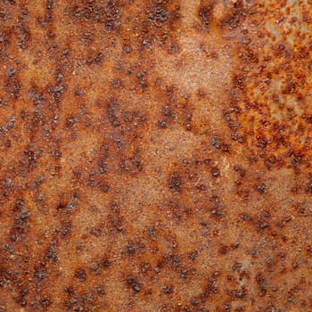 Closeup shot of old orange rust on the metal surface.