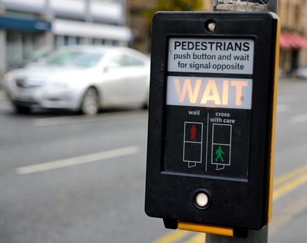 Crosswalk button for pedestrian with light warning.