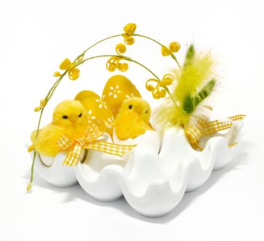 Easter decoration with eggs and small chickens on a white background.