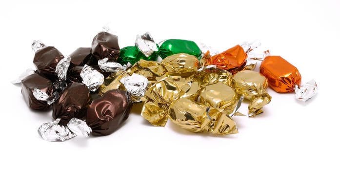 Packed candies in different color placed on a white background.