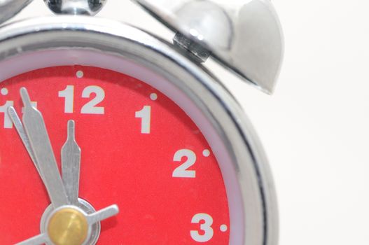 Closeup shot of alarm clock with red dial.