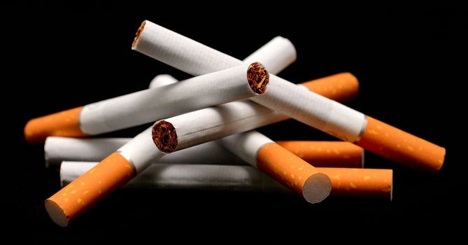 A pile of cigarettes on a black background.