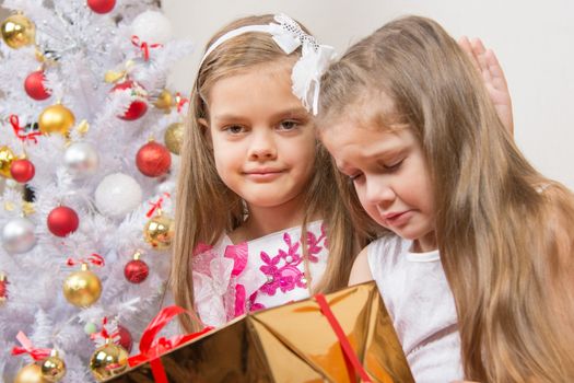 The girl gave the wrong gift, another girl comforting her
