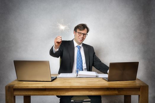 Image of business man with sparkler in office