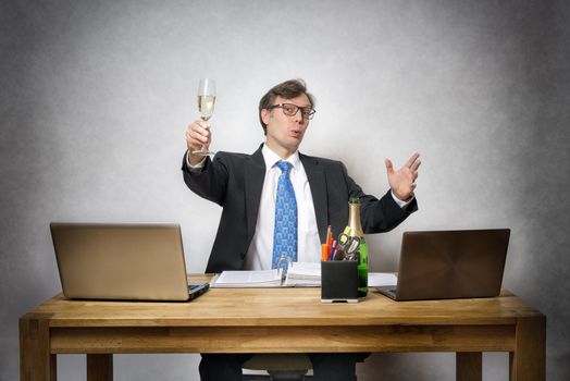 Image of happy business man with champagne glass in office