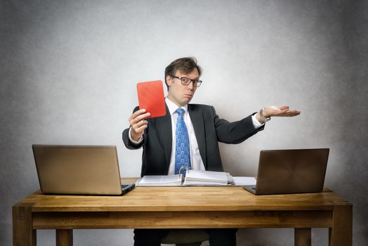 Image of business man with red card in office
