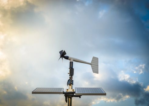 A solar powered anenometer against a dramatic stormy sky