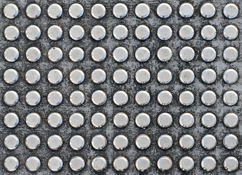 Studs tactile paving textured surface for blind or visually impaired people at a pedestrian crossing
