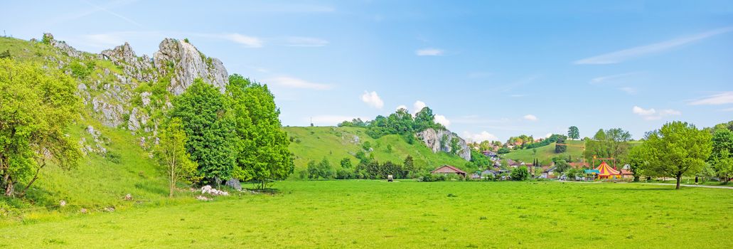 Rural panorama - farm and fair at town Eselsburg - the impressive rocks of valley Eselsburger Tal near river Brenz in foreground - jewel of the swabian alps
