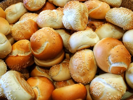 Freshly baked buns on display in a basket at the bakery