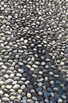 A background with an abstract pattern of well arranged stones on a floor                               