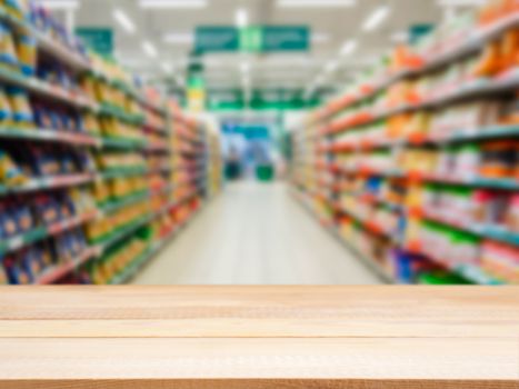 Wooden board empty table in front of blurred background. Perspective light wood over blur in supermarket - can be used for display or montage your products. Mock up for display of product.