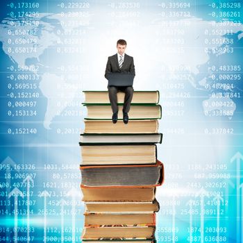 Businessman with laptop sitting on stack of books on blue background with arrows up
