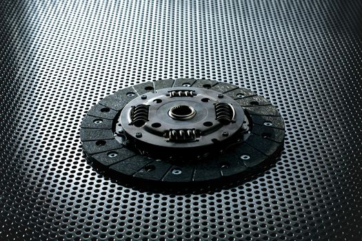 Car clutch on a metal surface. Photo from the classical vignetting effect it and a small depth of field