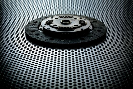 Car clutch on a metal surface. Photo from the classical vignetting effect it and a small depth of field