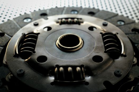 Car clutch on a metal surface. Photo from the classical vignetting effect it and a small depth of field
