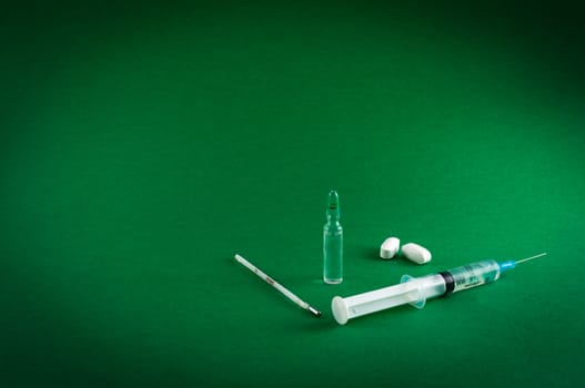 Closeup of medical tools and drugs on colored background