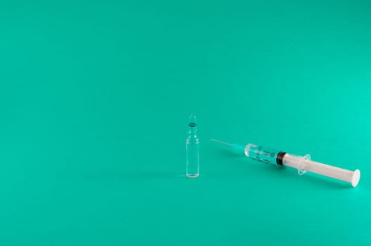 Closeup of medical tools and drugs on colored background