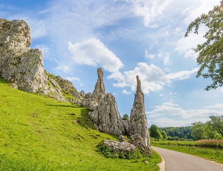 Rock formation "Steinerne Jungfrauen" in valley Eselsburger Tal near river Brenz - jewel of the swabian alps, meadow in front