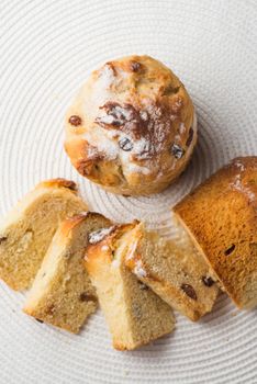 Homemade carrot muffin with empty space on white fabric background. Copyspace top view.