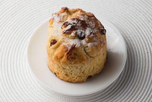 Homemade carrot muffin with empty space on white fabric background. Copyspace top view.