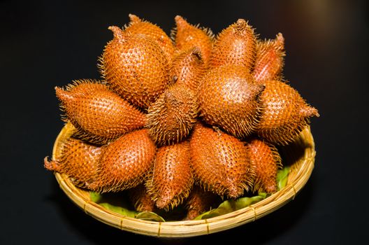 Wintergreen (Salacca wallichiana) on a basket. Wintergreen flesh is fruit seasonal of Thailand.