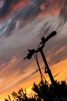 bicycle handlebars on a background of a dawn sky.