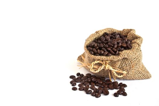 Coffee beans in canvas sack on white background
