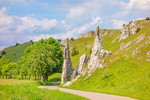 Rock formation "Steinerne Jungfrauen" in valley Eselsburger Tal near river Brenz - jewel of the swabian alps, meadow in front