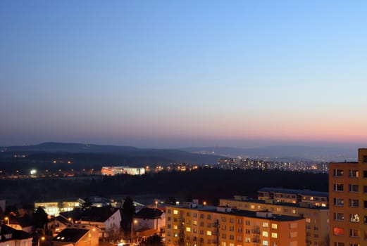 Housing development at sunset. Block of flats at night.