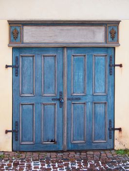 Old blue antique wooden door with padlock.