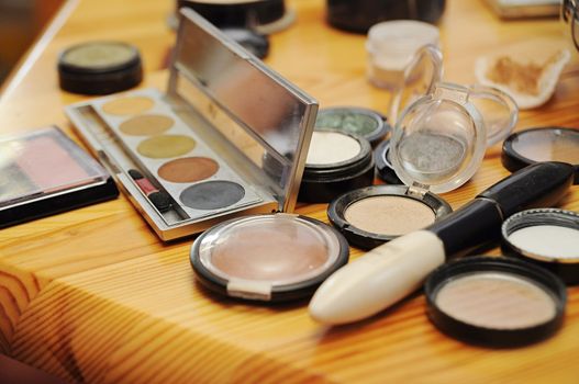 Closeup shot of colored eye makeup placed on the desk.