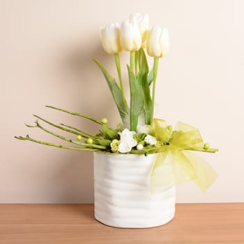 Interior decoration, decorative white tulips in the white flowerpot.