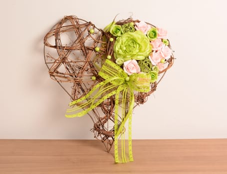 Interior decoration, decorative wicker heart with purple and green rose.