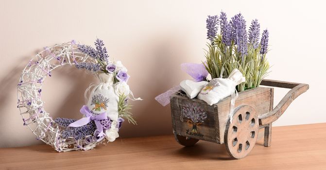 Interior decoration, decorative set with wicker wreath and wooden cart with Lavender.