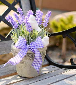 Lavender in the old pot on the bench. Home decoration.