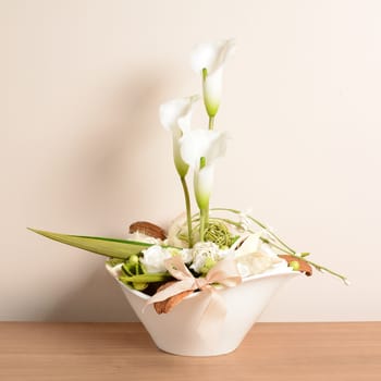 Interior decoration, decorative white calla in the white flowerpot.