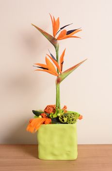 Interior decoration, decorative orange flower in the green flowerpot.