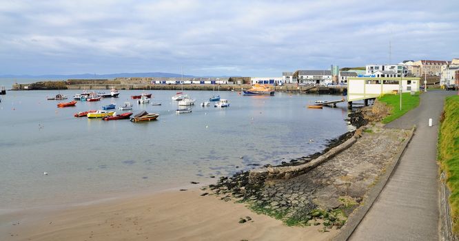 Small harbour with boats in the Portrush city, Northern Ireland.