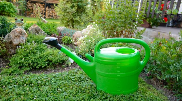 Plastic watering can in the garden.