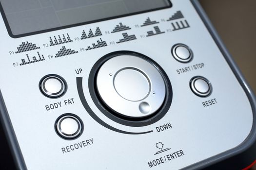 Control panel of the elliptical trainer with buttons and display.