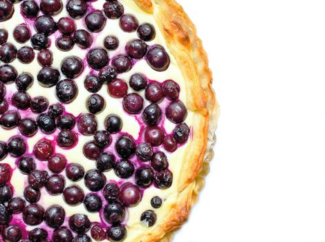 Top view on a blueberry cheese pie placed on a white background.