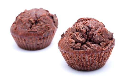 Two chocolate muffins on a white background. 