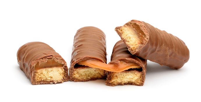 Chocolate bars with caramel and cookie on a white background.  Front view on a chocolate bars.