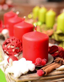 Christmas decoration with red and green candles closeup.