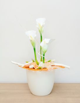 Closeup shot with home floral decoration on the table. White Kala flowers.