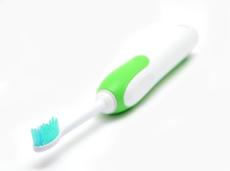 Electric toothbrush on a white background, closeup shot.