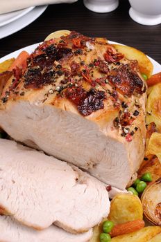 of roasted turkey breast slices with vegetables closeup