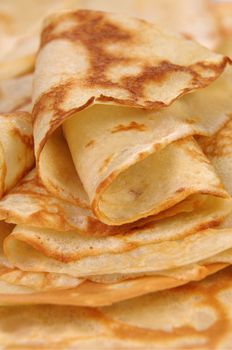 stack of folded crispy fried thin pancake closeup