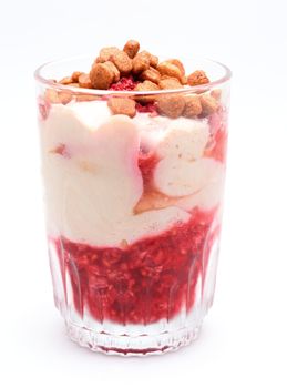 Curd cheese dessert with raspberries and small crunchies.